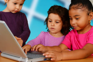 Group of children working on the computer at school